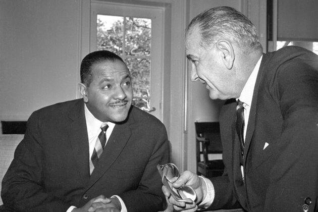 Carl Rowan sits with Lyndon B. Johnson in the oval office