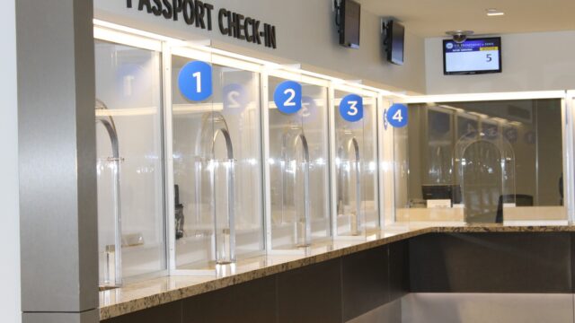 Passport check in counter with windows labeled by number.
