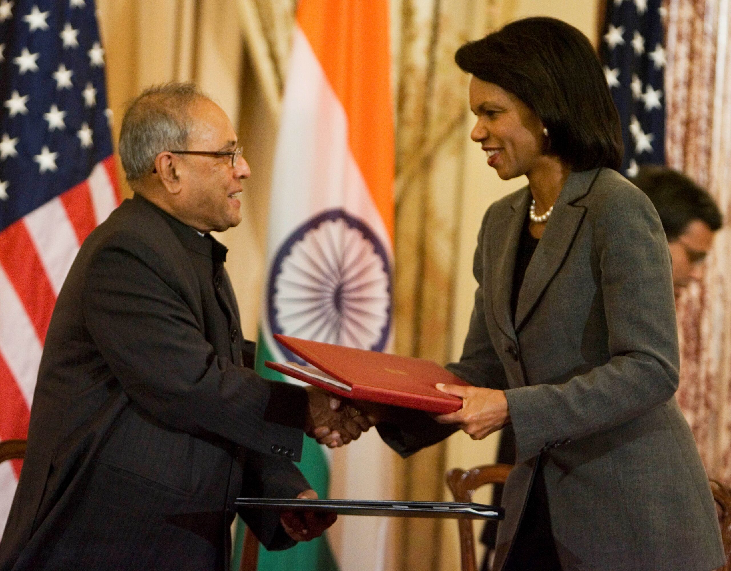 Condoleezza Rice shakes hands with Pranab Mukherjee