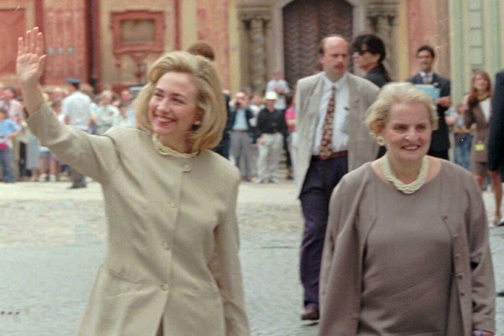 First lady Hillary Rodham Clinton, left, is accompanied by Madeleine Albright, U.S Ambassador to the United Nations, right, and waves to Prague citizens.