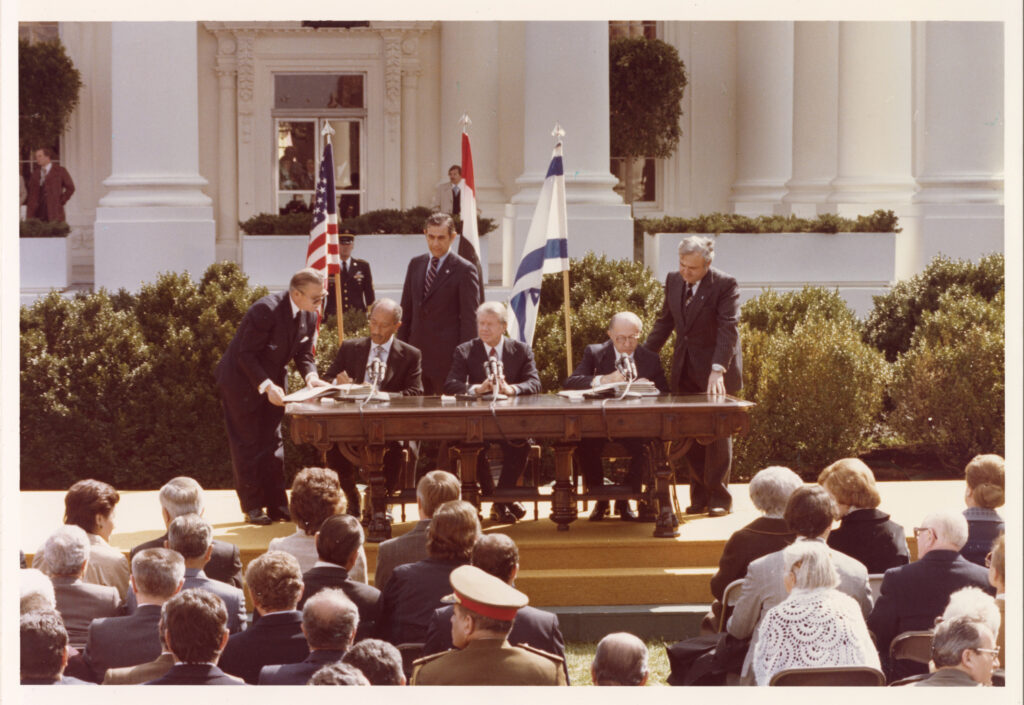 A group of men signing a treaty in front of the White House