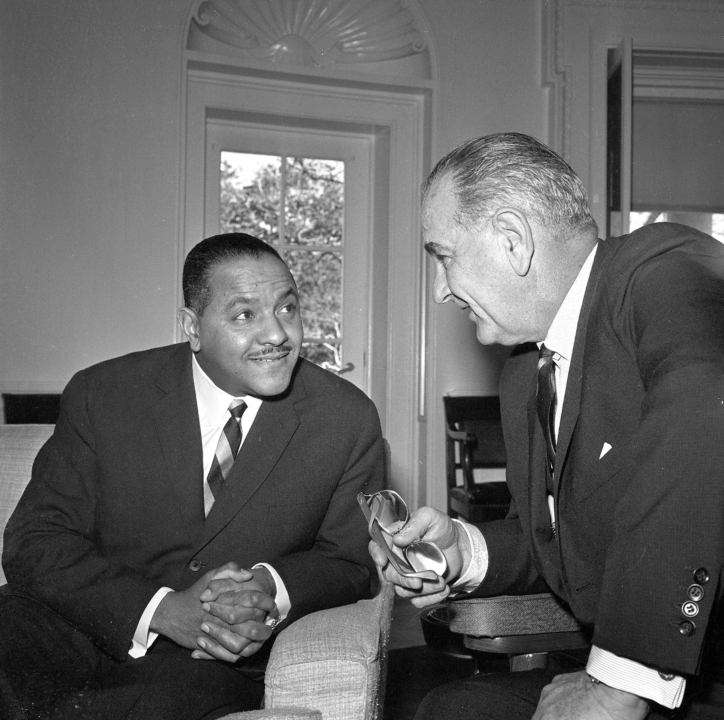 Carl Rowan speaks to Lyndon B. Johnson in the Oval Office