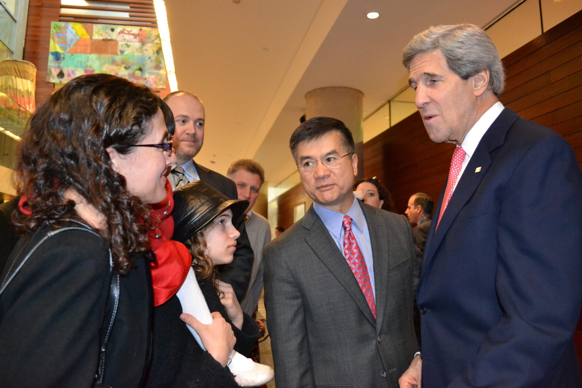 Erica Keen Thomas (left) speaks with U.S. Ambassador Gary Locke (center) and U.S. Secretary of State John Kerry (right).