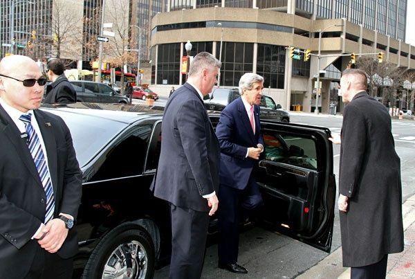 Secretary of state John Kerry, an older man at the time of this photo, gets out a limousine