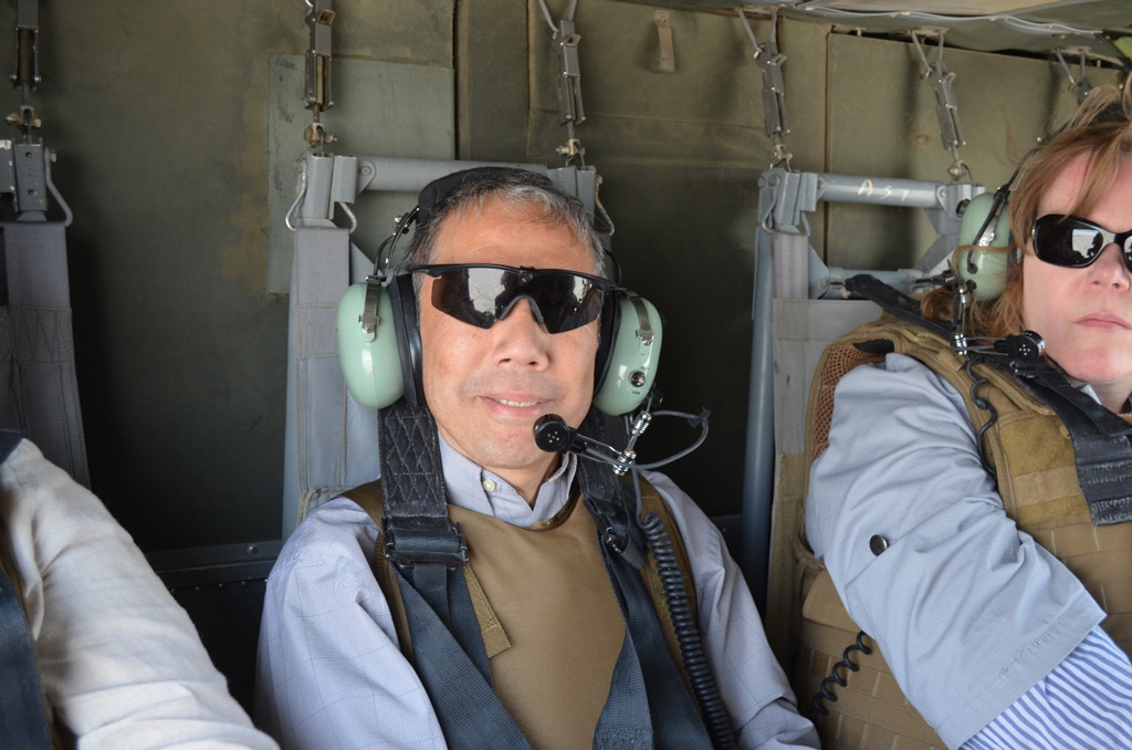 Yamamoto rides in a helicopter in Afghanistan