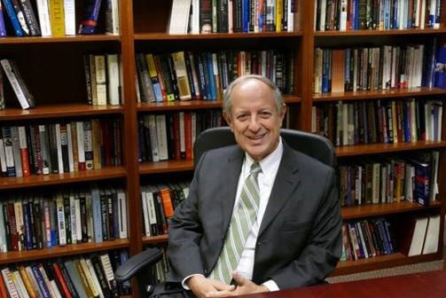 Gutierrez seated in front of a bookcase