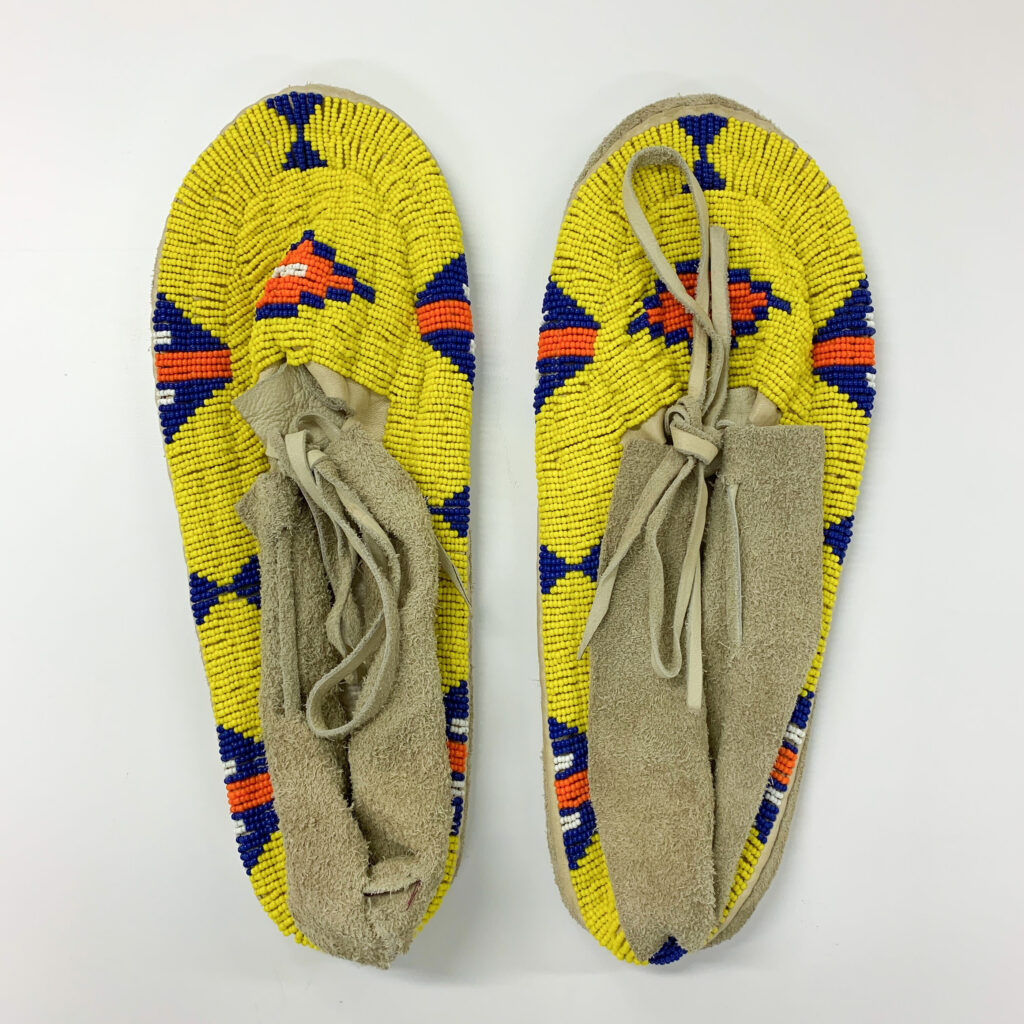 a yellow beaded pair of moccasins