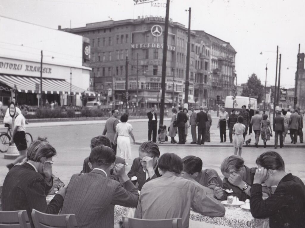 Young men from East Germany visiting West Berlin shield their faces from the camera to keep their identities from the Stasi, the East German secret police.