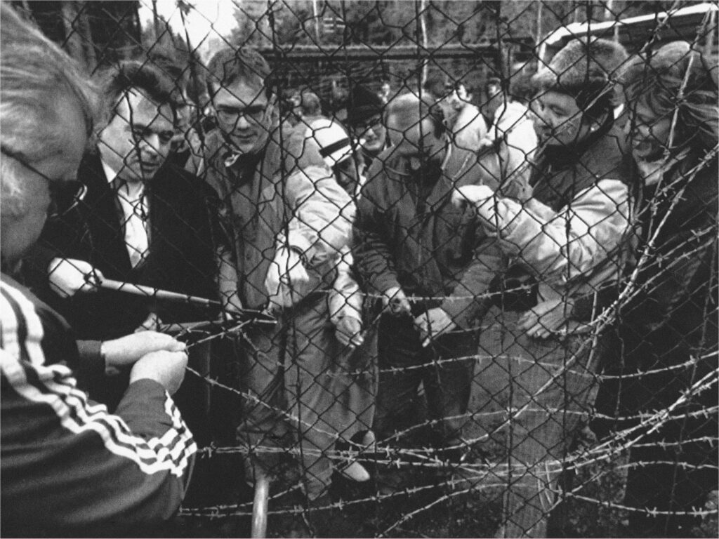 Citizens of Czechoslovakia and West Germany gleefully take apart a section of the “Iron Curtain” that separated their countries in Waidhaus, West Germany, December 23, 1989. 