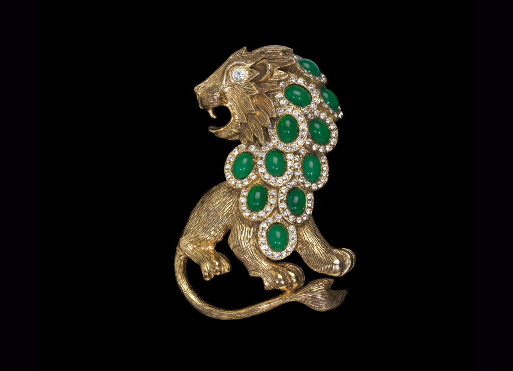 a gold lion with a green mane pin