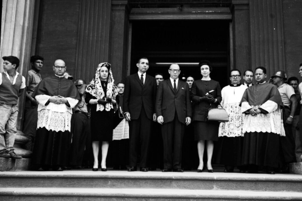 group of people in front of a church after a funeral