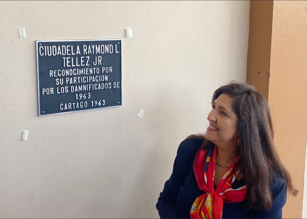 cynthia telles in front of sign