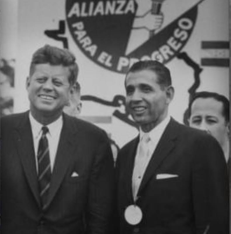 jfk standing next to telles