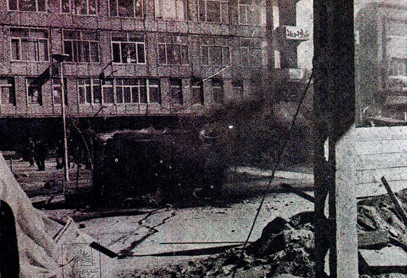 Smoldering debris in the streets of Tabriz during the revolution