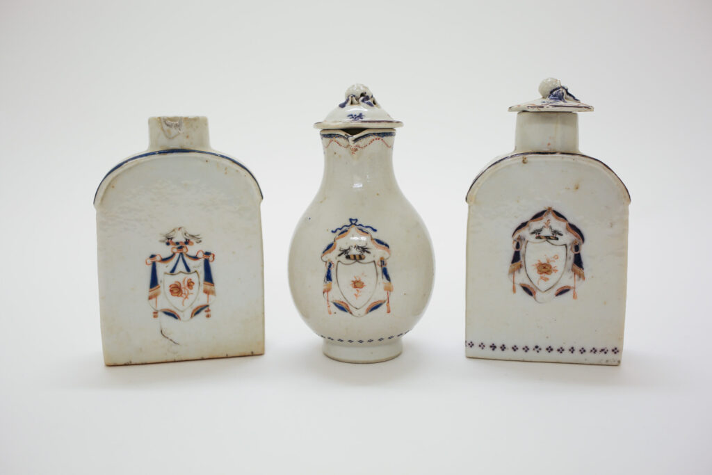 A set of white Chinese porcelain teaware with blue and gold decorations.