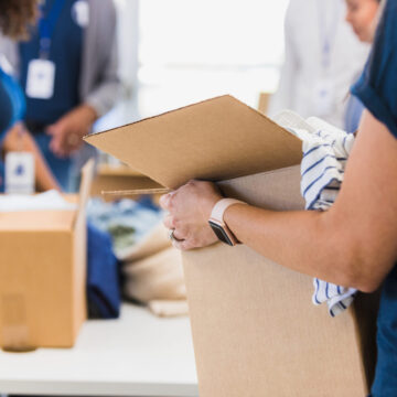 Person holding a cardboard box