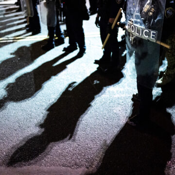 A group of police standing creates shadows