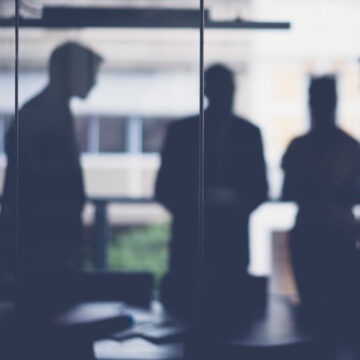 Silhouettes of businessmen in a conference room