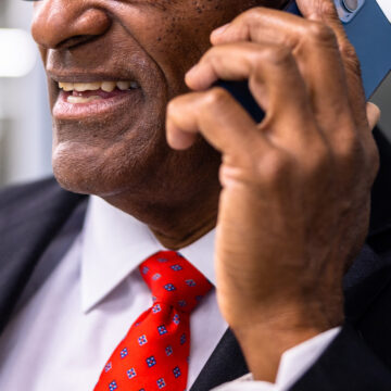 Man in a suit holding a phone