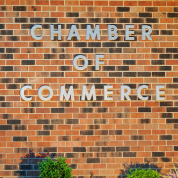 Chamber of commerce written on a brick wall