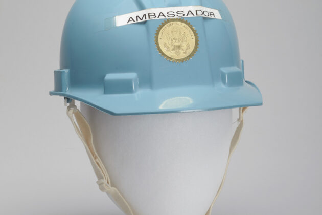Blue hard hat on a mannequin head with the word AMBASSADOR taped to the front.