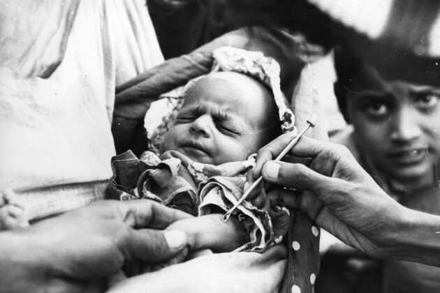 a baby in Pakistan receiving a smallpox vaccine