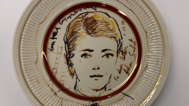 A small plate with an illustration of a woman's face.