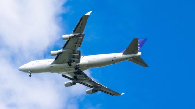 plane flying over blue sky