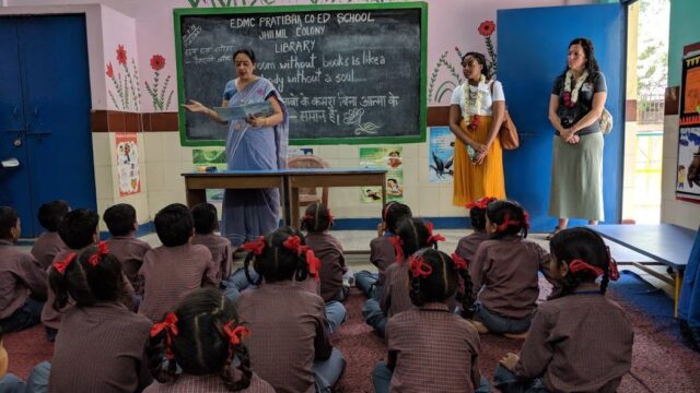 teachers stand in front of a classroom