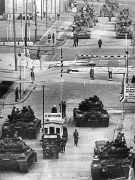 U.S. Army tanks, foreground, face off against Soviet tanks across the Berlin Wall at Checkpoint Charlie in a tense standoff, October 27-28, 1961.