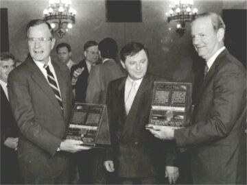 Hungarian Premier Miklos Nemeth presents U.S. President George H. W. Bush (left) and Secretary of State James Baker (right) with inscribed plaques containing a section of barbed wire removed from the Hungarian-Austrian border.