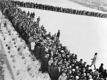 a line of refugees exiting east germany