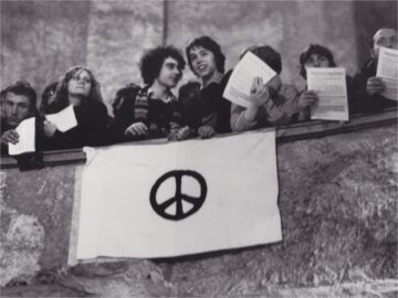 Students appear here at a 1982 Peace Forum in Dresden, East Germany, displaying a universally recognized sign for peace.