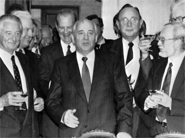 Foreign ministers signing the Two Plus Four Treaty in 1990 celebrate the move toward German unification. Pictured are Roland Dumas (France), Eduard Shevardnadze (Soviet Union), James Baker III (U.S.), Hans-Dieter Genscher (West Germany), Lothar de Maizière (East Germany) and Douglas Hurd (Great Britain) with Soviet President Mikhail Gorbachev, center.