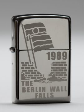 This silver Zippo lighter is etched with an outline of the broken Berlin Wall and two German flags celebrating unity.