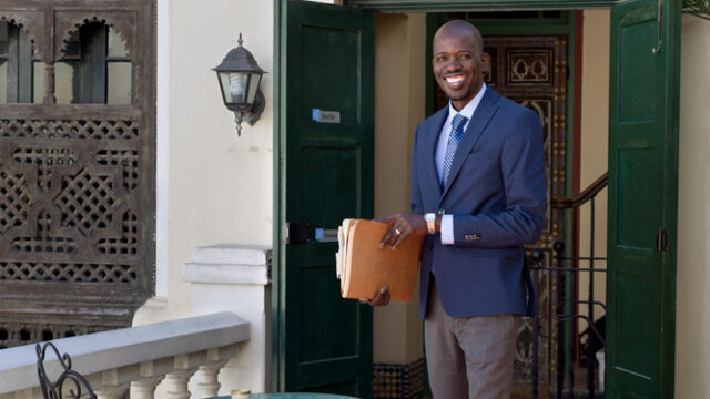 Lamine Kane in front of an embassy