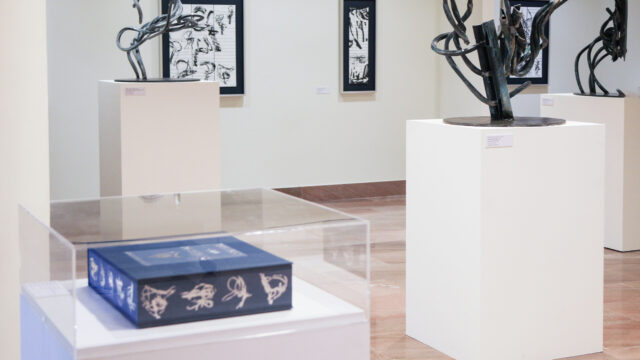 an exhibit with sculptures and an artist book