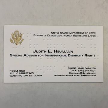 a white business card with judith heumann typed