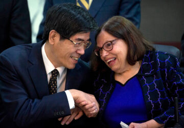 a man and a woman shaking hands while sitting