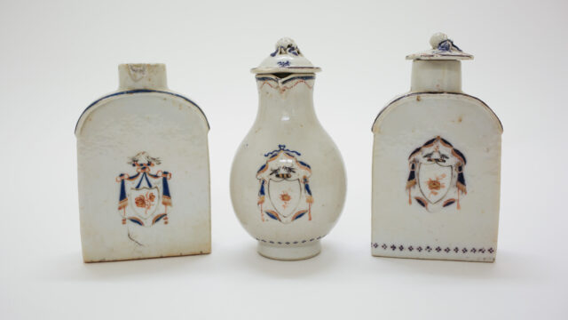 A set of white Chinese porcelain teaware with blue and gold decorations.