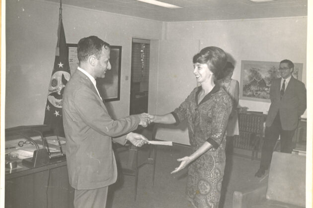 Patti Morton shaking hands with Ambassador Cohen