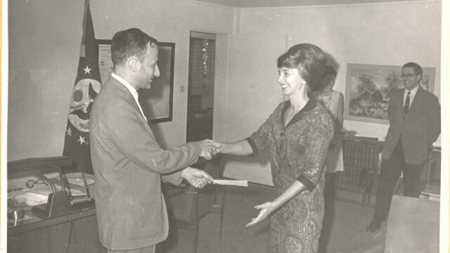 Patti Morton shaking hands with Ambassador Cohen