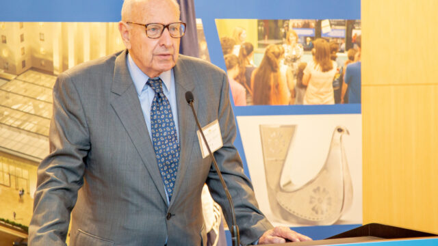 Diplomat at podium with background posters