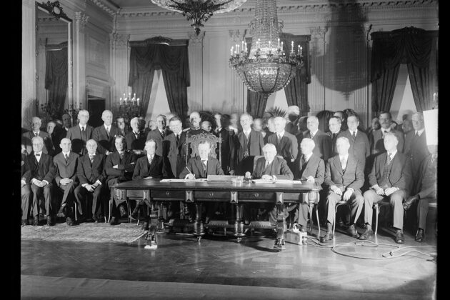 A posed group photo in black and white of the Kellogg-Briand Pact signing