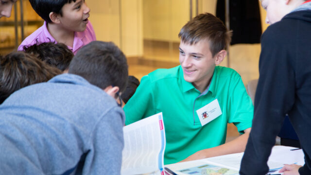 A group of students doing an in person diplomacy simulation