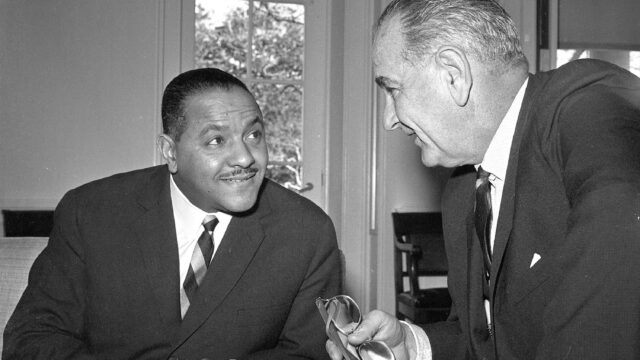 Carl Rowan sits with Lyndon B. Johnson in the oval office