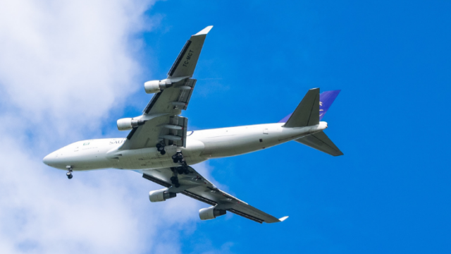 underbelly of plane in a blue sky