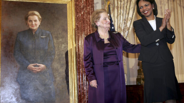 Condoleezza Rice and Madeline Albright stand together at the unveiling of the official portrait of Madeline Albright.