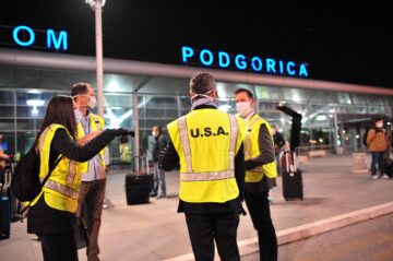 Staff of U.S. Embassy Podgorica gather outside the airport to assist in the return of U.S. citizens home from Montenegro.