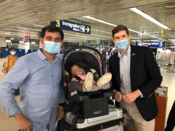 U.S. Ambassador to Bangladesh Earl Miller spends a moment with a dad and his sleeping child during repatriation efforts at the airport in Dhaka, Bangladesh.
